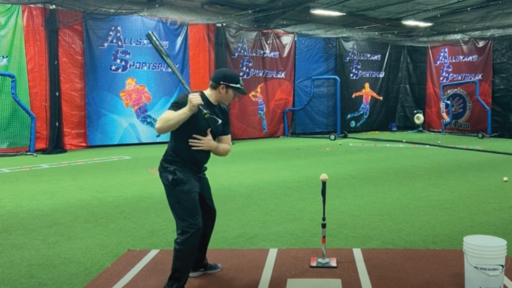 indoor batting cage with player up at bat