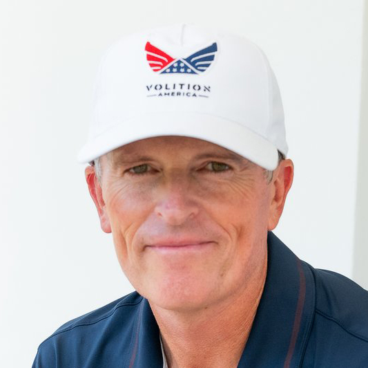 headshot of ryan crysler wearing a white hat and blue polo